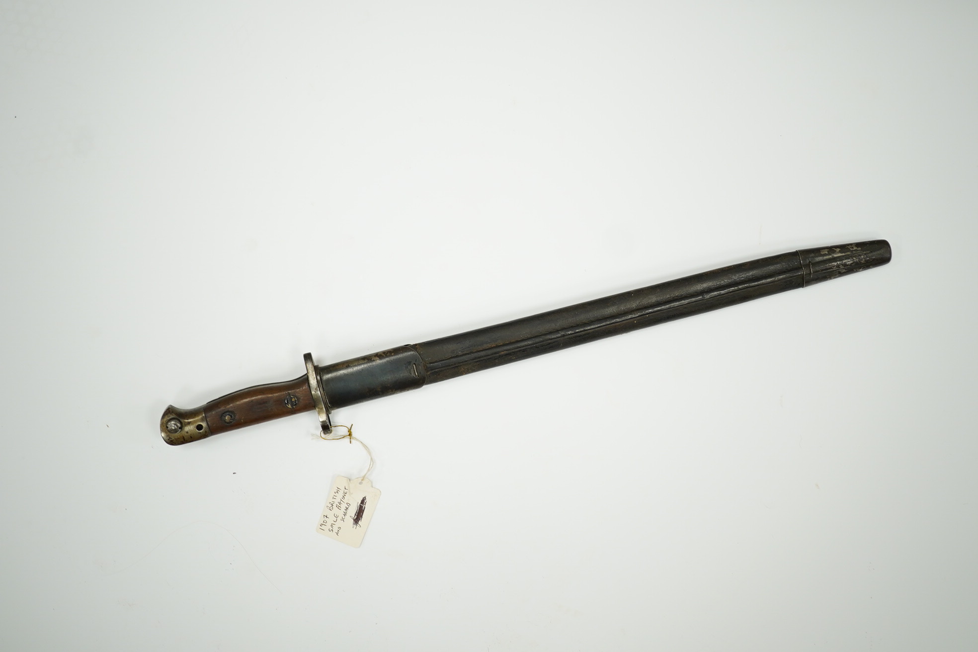 A 1907 pattern bayonet, the blade with issue stamp for 1918, with regulation hilt and in its regulation leather scabbard. Condition - good